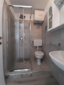 a bathroom with a shower and a toilet and a sink at Seven House Poetto in Cagliari