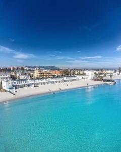 an aerial view of a beach with a large body of water at Seven House Poetto in Cagliari