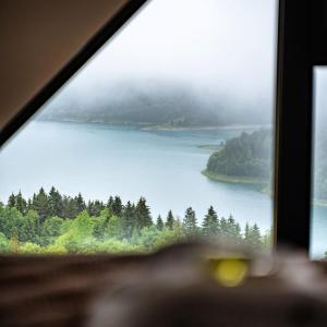 a view of a lake from a window at Villa Montana Zaovine in Bajina Bašta