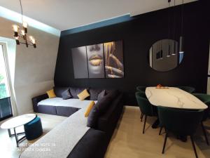 a living room with a couch and a table at Luxury City Center Cetinje Apartment in Cetinje