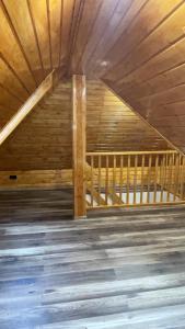 an attic room with wooden ceilings and a wooden floor at Penzion Loket in Loket