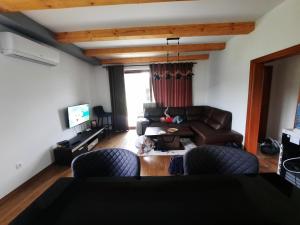 a living room with a couch and a table at Orahovo stone vilas in Virpazar