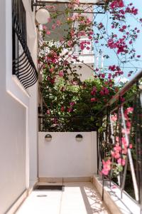 a white door with pink flowers on a balcony at A & D Houses in Patra