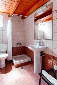a bathroom with a sink and a toilet at A & D Houses in Patra