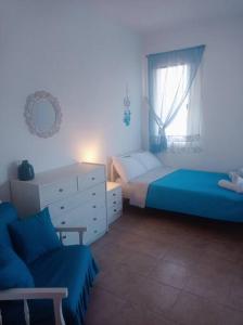 a bedroom with two beds and a chair and a window at Welcome Home in Kómi