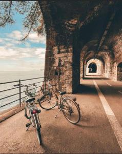 two bikes parked next to a wall next to the ocean at Casa Sant'Anna in Levanto