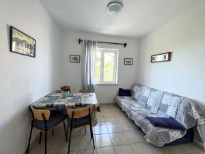 a living room with a couch and a table at Central Studio Apartments & Dormitory Rooms in Supetar