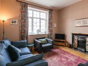 a living room with a couch and chairs and a television at 76 High Street in Redcar