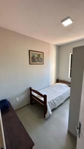 a bedroom with a bed and a picture on the wall at Hotel Bandeirantes de SJBV in São João da Boa Vista