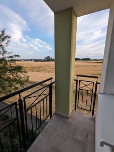 a balcony of a house with a view of a field at N&H Pansion 