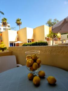 a bowl of lemons sitting on a table at El Cortijo Bungallows in Playa de las Americas
