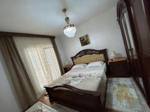 a bedroom with a bed and a chandelier at Apartments Gazi in Ulcinj