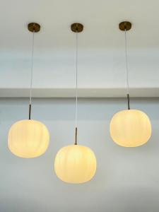 a group of three lights hanging from a ceiling at Gerani Deluxe Houses 2 in Astypalaia Town