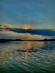 a sunset over a large body of water at REMAR - Apartamenty z widokiem na Jezioro Biale in Augustów