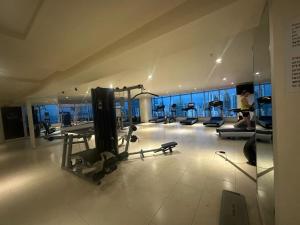 a gym with treadmills and machines in a building at Grand Bay Tower in Panama City