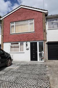 a brick house with a car parked in front of it at CHATHAM GUEST HOUSE in Chatham