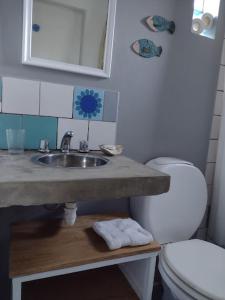 a bathroom with a sink and a toilet at Trotamundos CASA in Puerto Pirámides