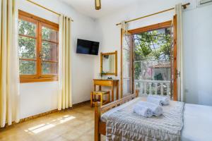 a bedroom with a bed and a window at Panagou Studios in Skopelos Town