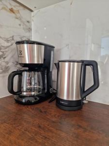 two coffee pots sitting on top of a counter at Apartamenty Malaga II in Darłowo