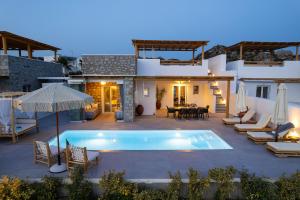 a villa with a swimming pool and a patio at OLIVES seaside villas (4elies) in Plaka