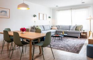 a living room with a table and a couch at Cabot Views by Revelstoke Vacations in Revelstoke
