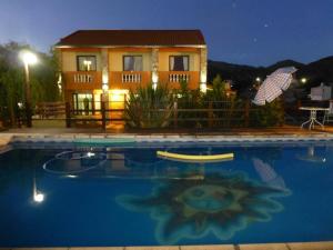 a house with a swimming pool in front of a house at Cabañas Lunas y Soles in Potrero de los Funes