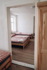 three beds in a room with a mirror at Usedlost Jindřichovice 