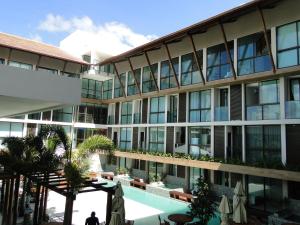 an external view of a building with a pool at SUNNY HALL in Porto De Galinhas