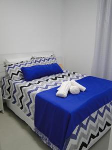 a bed with two towels on top of it at SUNNY HALL in Porto De Galinhas