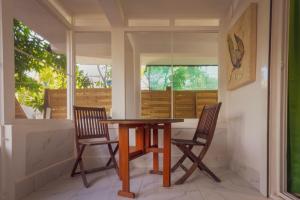 a dining room with two chairs and a table at Pierre's Place Grand-Case, a place to dream in Grand Case