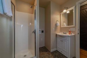 a bathroom with a shower and a sink at Elk Meadow Cabins 13B Bears Den - Single Room in Orick