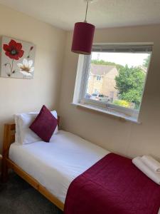 a small bedroom with a bed with a window at Field Avenu in Kent