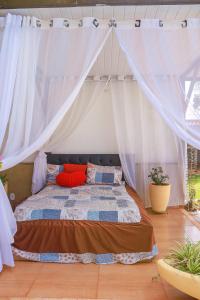 a bedroom with a bed with a canopy at Portal Da Mata in Santa Fé do Sul