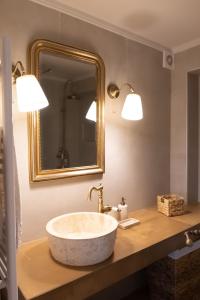 a bathroom with a sink and a mirror at ANESIS Luxury Apartment in Lefkada Town