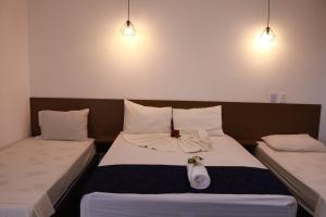two beds in a hotel room with at Portal Da Mata in Santa Fé do Sul +38 photos