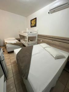A bed or beds in a room at Pousada Schmitz