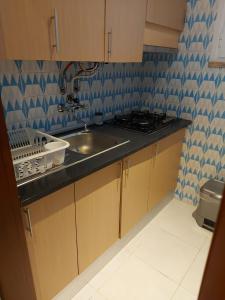 a kitchen with a sink and a stove at Your Home near the beach - Sesimbra in Sesimbra