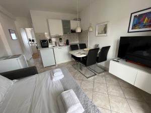 a living room with a dining table and a kitchen at La Fee studio apartment in Hvar