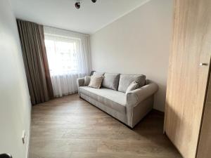 a living room with a couch and a window at Apartment in Birstonas in Birštonas