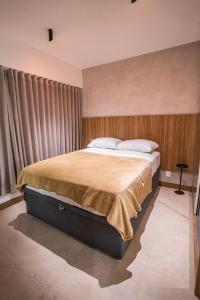 a bedroom with a large bed with a large window at Apartamento novo de alto padrão e aconchegante#223 in Brasilia