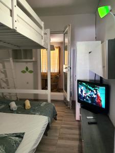 a bedroom with two beds and a flat screen tv at UNIQUE Apartments Malinska in Malinska