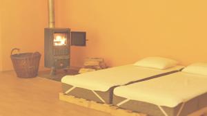 a room with a bed and a fire stove at Nezámek in Hartmanice