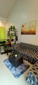 a living room with a couch and a table at Misty Hills Guesthouse Amadeo - Tagaytay in Amadeo