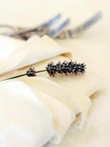 a bunch of purple flowers on a white table at Hotel La Pigna in Marina di Pietrasanta