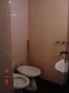 a bathroom with a toilet and a sink at Emperatriz HOTEL familiar in Santa Fe