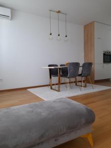 ein Wohnzimmer mit einem Esstisch und Stühlen in der Unterkunft Apartman Lena in Banja Luka