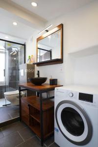 a bathroom with a washing machine and a sink at F2 Type LOFT à Ajaccio in Ajaccio