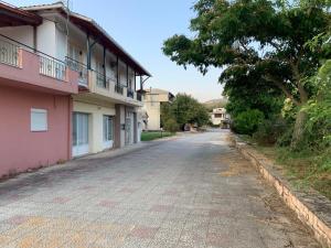 an empty street in front of a building at Vasilis home apartment in Mazarakiá