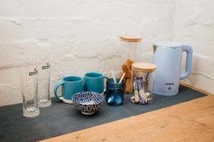a counter topped with cups and mugs on a table at Mooi Uitsig Lodge in Paarl