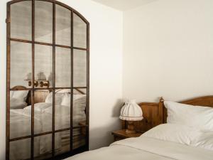 a bedroom with a large mirror next to a bed at Enzian Inn in Leavenworth